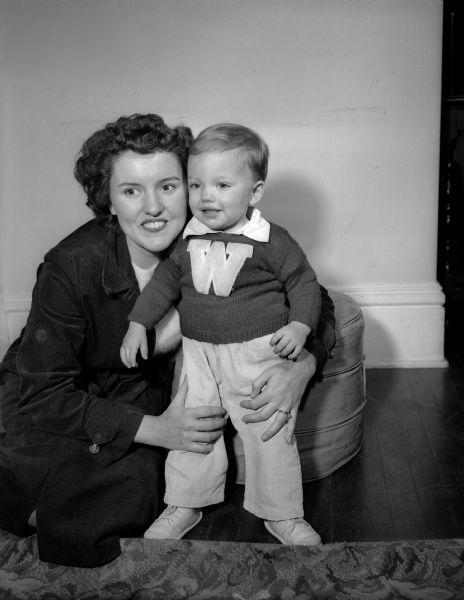 Doris Elliott poses with her 14-month-old son, Bobby.  They are the wife and son of Bruce K. Elliott, tackle on the University of Wisconsin football team.
