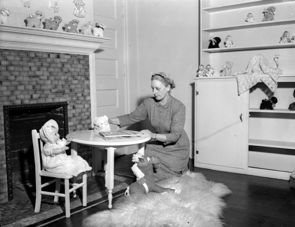 Mrs. Dorothy Rainey arranging a children's corner in the Old Rectory Shop at Grace Episcopal Church, located at 116 West Washington Avenue. The shop is the permanent home of Swap 'n Shop, with proceeds going to the church.