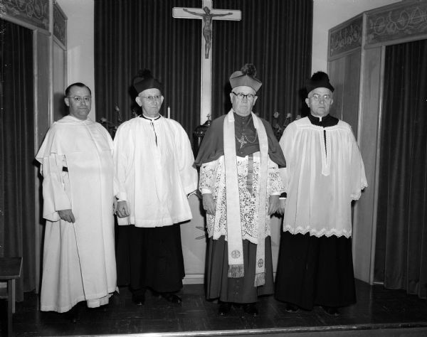 Posed in the chapel of the new Blessed Sacrament Convent are, (left to right): Reverend John B. Schneider, pastor of Blessed Sacrament church; Reverend John A. Koelzer, pastor of St. James church; Bishop William P. O'Connor, who officiated at the blessing ceremony; and Reverend F.L. McDonnel, pastor of Our Lady Queen of Peace church.