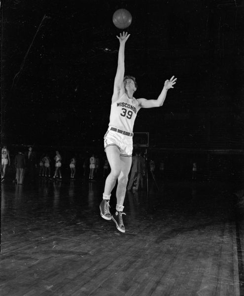 One of four individual portraits of action shots of University of Wisconsin basketball players (#23, 39, 40, and 42) from the 1949-50 season team.