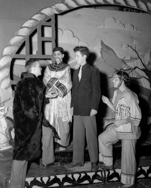 A scene from the East High School production of "Lost Horizon."  Left to right are James Bidgood, Arland Rosenbloom, Stanley Stitgen, and Marlene Radl.