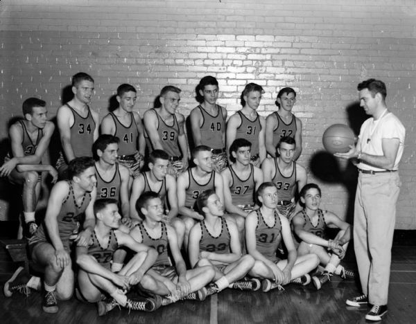 Group portrait of Central High School boy's basketball team with Coach Bobby Alwin.