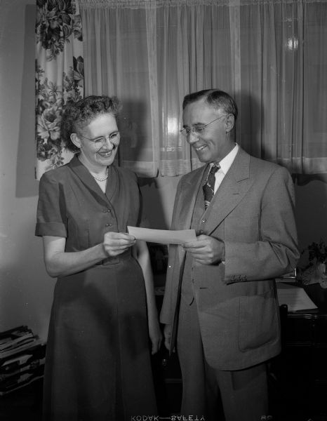 Mrs. LaVone Wipperfurth of 2526 E. Dayton Street receiving a $200 prize check from  J.R. Warren, Milwaukee, branch manager of Pillsbury Mills.  Mrs. Wipperfurth will also be sent, all expenses paid, to New York City.  There in the Waldorf Astoria hotel ballroom she will compete against 99 other national winners. The ultra-modern push-button range on which she will bake her rolls for judging will also be a gift to her.