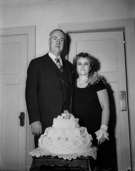 W. Jerome & Dora Higgins celebrate their 25th wedding anniversary with a cake in their home at 316 Grand Avenue. Jerry Higgins is blind and runs the newsstand in the state capitol.
