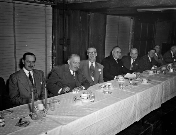 Guests sit around the head table at the testimonial banquet given by the Rounders' Club for State Journal columnist Roundy Coughlin.  Pictured from left to right are:  Don Anderson, State Journal publisher; Fred Saddy, secretary of the Wisconsin Boxing commission; Roundy; Tommy Gibbons, former great heavyweight boxer who delivered the main address; and Joe Woolsey, toastmaster.