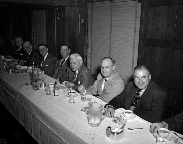 Guests sit around the head table at a testimonial banquet given by the Rounders' Club for State Journal columnist Roundy Coughlin. Pictured from left to right are: Al W. Barels, Madison city clerk; Eddie Corcoran, long-time club member; Superior Judge Roy H. Proctor; Al Larson, club secretary; and Ole Severson, club treasurer.
