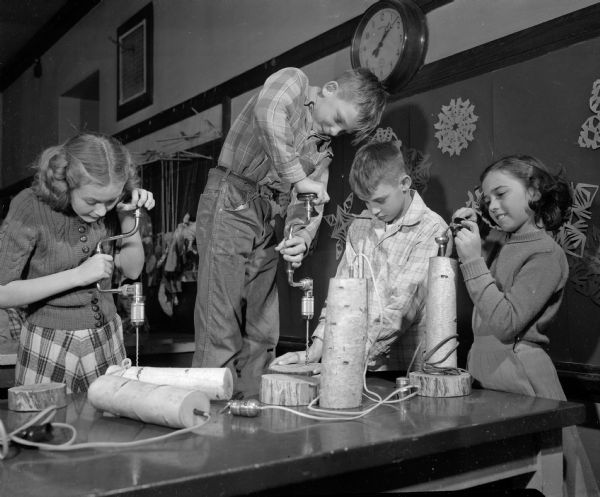 Sixth grade students at Emerson School make lamps in an art class. From left are: Patsy Downs, Wesley Lovejoy, Jerry Ott, and Darlene Butler.