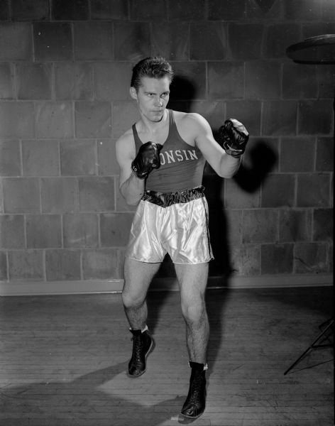 One of two University of Wisconsin boxers entered in the sixteenth annual Tournament of Contenders held at the University of Wisconsin fieldhouse. Individual portraits are of Don Schuster, a 175 pounder from Chicago, and Dick Murphy, a 165 pounder.