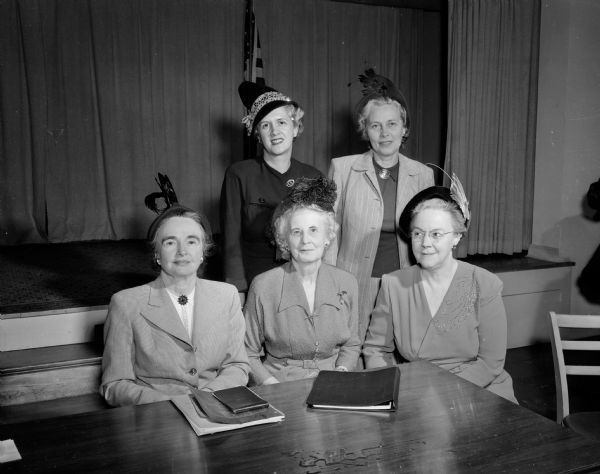 Officers of the newly formed Madison General Hospital Women's Auxiliary. Seated, left to right: Mrs. Jerome (Helen) Coe, president; Mrs. S L. Odegard, first vice-president; and Mrs. Marshall (Vera) Browne, secretary. Standing:  Mrs. H. Stanley (Mary) Johnson Jr., second vice-president; and Mrs. Basil I. (Nettie) Peterson assistant treasurer.