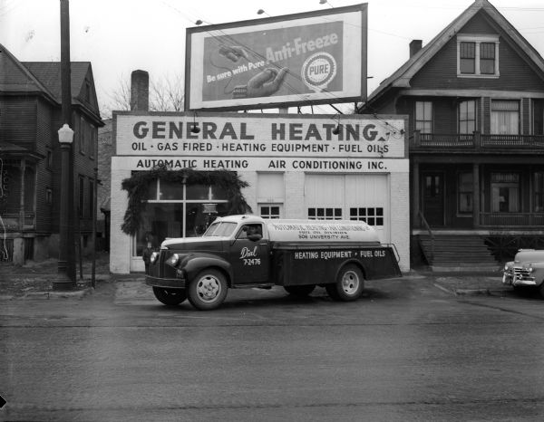 A fuel oil truck parks in front of a building labeled "General Heating" at 506 University Avenue.