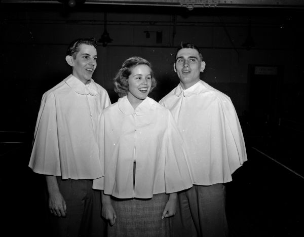 Three singers participate in the annual Christmas pageant presented by Madison high school students in the Wisconsin State Capitol building. From left are Al Gay, West; Jane Spencer, East; and Dick Olson, East.