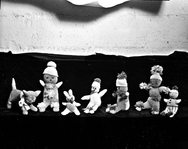 A display of stocking dolls, rabbits, and cats made by members of the Margaret Street Club for distribution to underprivileged children by the <i>Wisconsin State Journal</i> Empty Stocking Club.