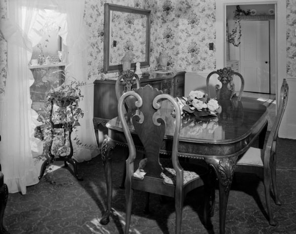 View of the Georgian dining room decorated with floral wallpaper in the dining room of the William C. Treichel above-store apartment in Marshall.