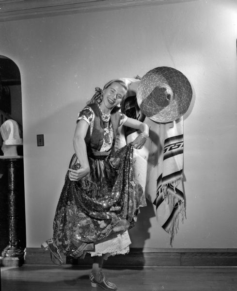 Christine Brinsmade is shown in Mexican costume doing an authentic Mexican dance at the Madison Woman's Club "Posada Mexicana" Christmas folk festival.
