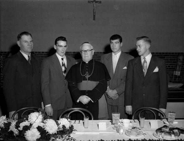 Annual banquet for the Edgewood High School football team held in the school cafeteria.  Left to right: Earl Wilke, head coach; Dean Corcoran, voted most valuable player; William P. O'Connor, bishop of Madison; and Norbert Esser and John Lang, co-captains for the past season.