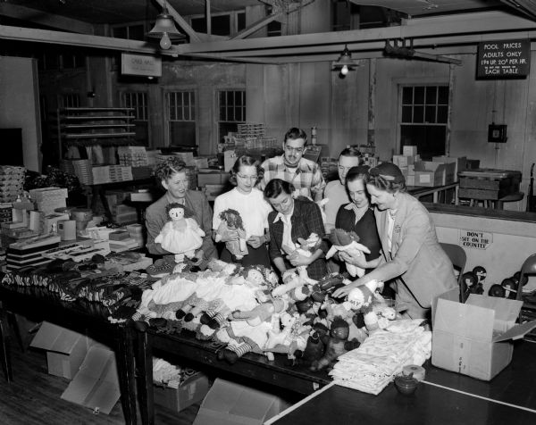 Dozens of contributed stuffed toys are examined by volunteers for The State Journal Empty Stocking Club. In the front row, left to right, are: Alice Shores; Dorthy French, editor of The State Journal's home page; Althea Powers; Josephine Doudna, chairman of the Empty Stocking Club, and Mrs. George C. Morris, manager of the club's Holiday Exchange. In the back row are John Tews and Bill Doudna, Jr.
