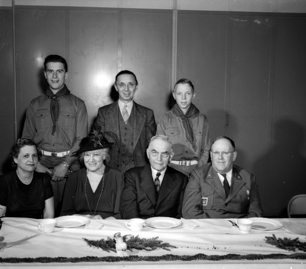 Group portrait of people at the head table at a banquet held at the Naval Reserve Training Center, 1046 E. Washington Ave. L to R front row: Mildred Norg (wife of Peter Norg, council scout executive); Lois Rosenberry; Marvin B. Rosenberry - Chief Justice Wis. Supreme Court; C. H. Beebe - Drum and Bugle Corp Director.  L to R back row: Leon Petterson, corps member; Lester Fleury, corps Vice Chairman; Freddy Fleury, corps member.