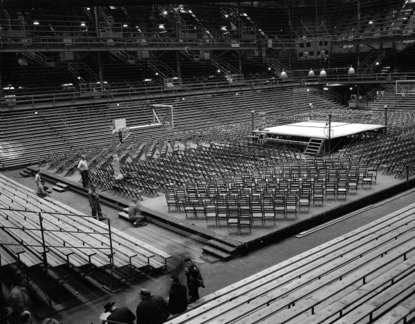 One of five photographs of the University of Wisconsin fieldhouse being set up for a boxing match.