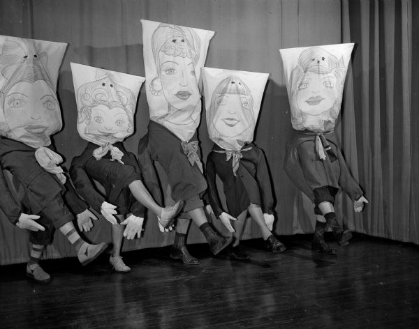 Dancers at Nakoma's 12th Night Party perform while wearing masks. They are, from left to right, Professor John F. Stauffer, Perle Knope, Lyman Frazier, Ruth Goetz, Robert Goetz.