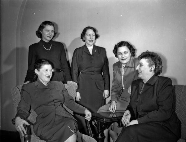 Group portrait of some of the committee members of the Madison section of the National Council of Jewish Women as they plan a benefit cabaret party. Sitting left to right are: Mrs. Julius (Bertha) Giller, 1110 Seminole Highway, co-chair of arrangements; Mrs. Herschel (Arlene) Rotter, co-chairman of sponsors; and Mrs. Rose Benjamin, 146 Langdon Street, general chairman. Standing left to right are: Mrs. Robert (Bella) Levine, 2103 Keyes Avenue, co-chairman of ticket sales, and Mrs. Harry (Marjorie) Tobias, 2324 Kendall Avenue, co-chairman of sponsors.