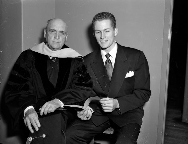University of Wisconsin-Madison President E.B. Fred with senior class president F. Anthony Brewster at the first convocation for a mid-year graduation. President Fred is wearing his academic cowl.