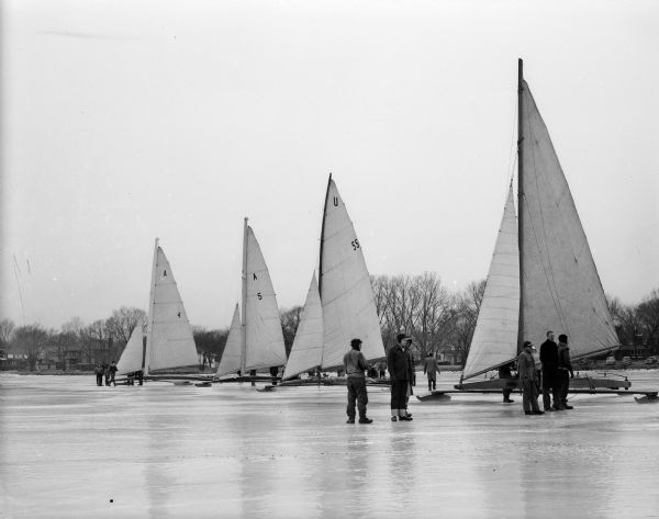 Iceboats line up on Lake Monona for the Hearst Trophy Iceboat Race. Shown are Madison iceboats "Fritz" and "Mary B," and Oshkosh iceboats "Penguin" and "Flying Dutchman."