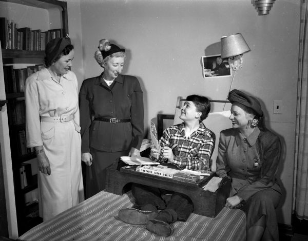 Three women who will take part in the Madison Heart Fund Drive visit with Dennis Swanson of Shopiere who is a patient at the Rheumatic Fever Convalescent Home on Old Middleton Road. From left are Mrs. Mortimer (Mary) Huber, Mrs. J.B. (Esther) Hermsen, and Mrs. Laurence W. (Virginia) Hall.