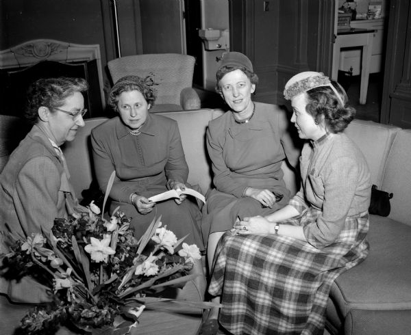 Third district officers of the Wisconsin State Nurses' Association sitting on a sofa while planning a banquet. Left to right: Margaret Emanuel; Janet Jennings, chair of the program committee; Martha Jenny, third district president; and Josephine O'Neill.