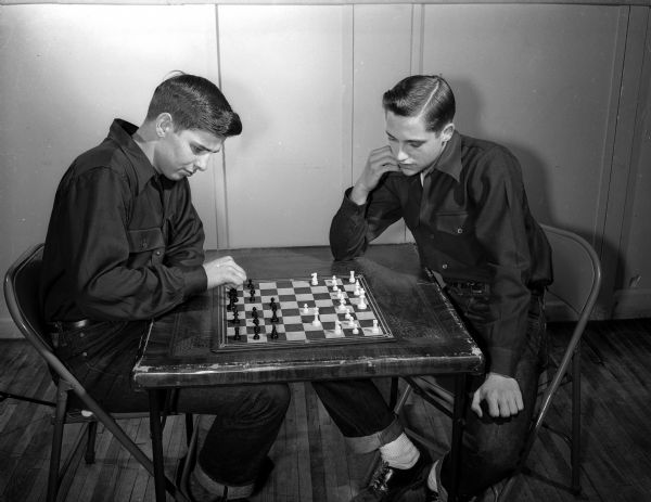 Eugene Fraser (left) and Vernie Lapan play chess at the anniversary dance at the Loft Community Center, 16 East Doty Street.