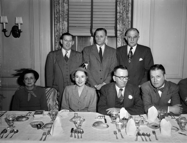 Group portrait of the committee for the 1950 Heart Campaign. Seated left to right: Mrs. James (Anya) Castle, Ladies Committee Chairman; Mrs. Frederick (Violet) Miller, Committee Secretary; Dr. Ovid O. Meyer, Wisconsin Heart Association; and Perry Armstrong, Business Committee Chairman. Standing left to right: Wilbur K. Bakke, Assistant Chairman; Charles W. Ellis, District Chairman; and Leo J. Blied, Campaign Chairman.
