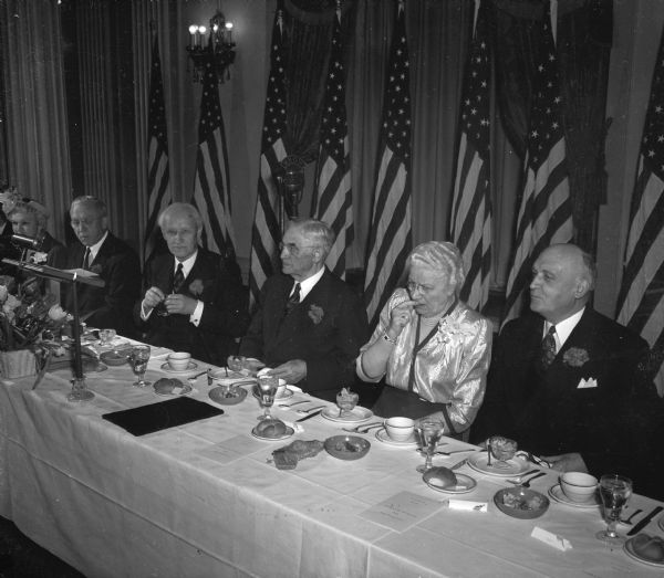 Chief Justice Rosenberry is seated at the head table with (left to right), Mrs. Oscar (Mary) Rennebohm, Gov. Oscar Rennebohm; Prof. William H. Kiekhofer; Justice Rosenberry; Mrs. Lois Rosenberry, and the University of Wisconsin Pres. E.B. Fred, at a testimonial banquet at the Hotel Loraine. The event honored Rosenberry's 34 years of service in the state's highest tribunal.