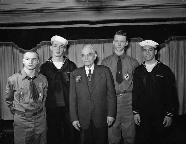 An honor guard of Boy and Sea Scouts was provided to Justice Marvin B. Rosenberry, who has long been active as a community Scout leader, at a banquet Sunday night honoring the retired chief justice of the Wisconsin supreme Court.
Shown are, left to right: Paul Green, Sea Scout, Ship 502; David Zimmerman, Boy Scout Troop 9; Robert Bell, Sea Scout, Ship 501; and Stefan Anderson, Troop 20.
