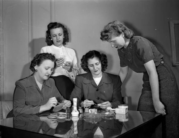 Members of the University of Wisconsin Dames Club handicraft group  making gifts out of small shells. Four members, shown left to right, are: Mrs. Alexander (Grace) Galetsky, 412 W. Gilman St.; Mrs. Thomas F.(Constance) Garland, Jr., 315 N. Murray St; Mrs. Noel E.(Harriett) Hogue, 42 Corry St., and Mrs. Norval G.(Dolores) Brown, 217 N. Brooks St., chairman of the group.