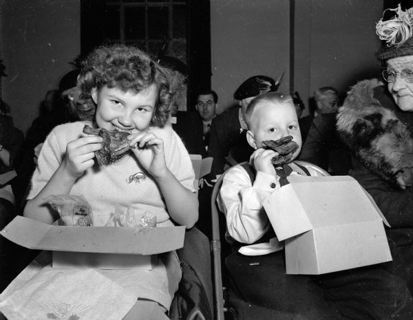 Two "young" Rebublicans, Dorothea and Lyle Siggilkow, McFarland, are shown enjoying a fried chicken box supper at the Lincoln Day Dinner.
