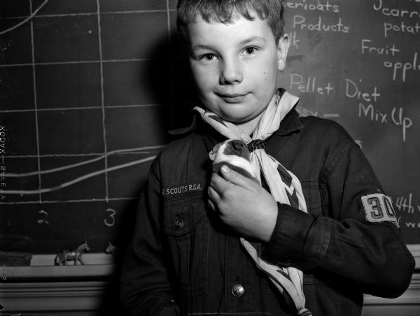 Randall school student John Drake, wearing a Boy Scout uniform, holding his classroom's newborn guinea pig named "Mix-Up, Jr."