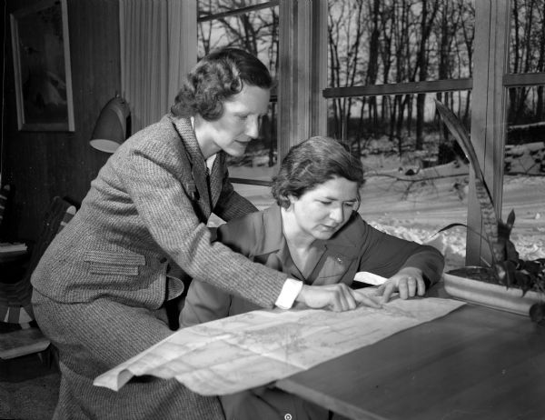 League of Women Voters members Elizabeth Antonius (left), 221 South Owen Drive, and Josephine Jenkins, 2805 Sylvan Avenue, study a map in preparation for a house to house voter registration campaign.
