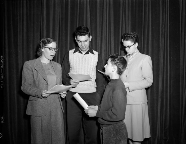 Four actors rehearse for the play "Last Flight Over."  From left to right are Pat Burrell, Dave Vogel, Walt Kirchberger, and Kay Esch.