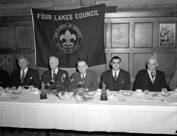 Boy Scout - Four Lakes Council annual dinner head table. Left to right are: John A. Raymond, scout commissioner; Dr. Albert E. Iverson, national director of Protestant relationships of the Boy Scouts of America; Harlan C. Nicholls, past president of the Four Lakes council;  Edward E. Bryant, council president; and Marvin Rosenberry, former chief justice of the state supreme court. Award recipients named in article.