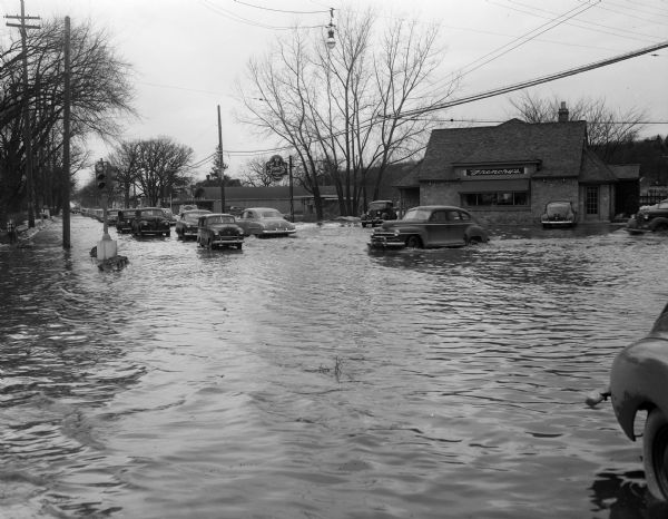 Flooding along University Avenue at Shorewood Boulevard in front of Frenchy's restaurant, 3302 University Avenue.