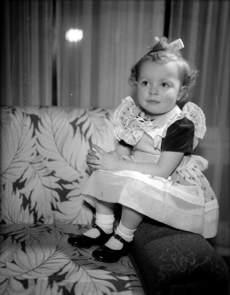 This little Irish miss is 2 1/2-year old Sally Anne O'Malley, daughter of Mr. and Mrs. Robert Connor (Mary) O'Malley, 202 South Allen Street.