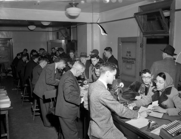 Taxpayers trying to meet the State and Federal March 15, 1950 deadline crowd the United States Internal Revenue Service Tax Office.