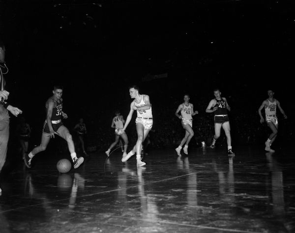 View of a Thursday game during the boy's high school basketball tournament.  Some teams and players can be identified by reference to other published photos from this tournament.