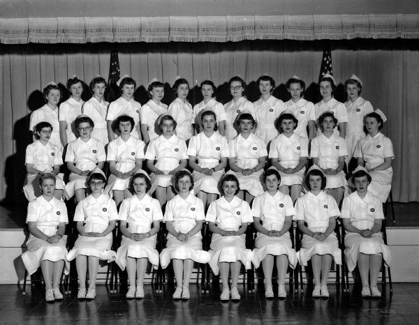 Group portrait of 29 Madison General Hospital student nurses who completed their pre-clinical training. Taken following a ceremony in which each student received a nurse's cap.