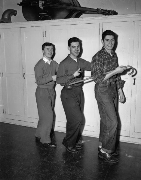 Claude Burdick, Dave Vogel, and Lowell Froker (left to right) of Wisconsin High School practice for the "cake walk" portion of the school's old-fashioned minstrel show.