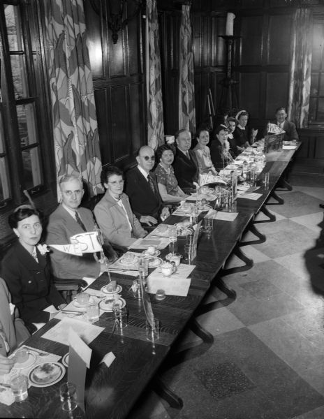 Dr. Robert West, director of the University of Wisconsin speech clinic, was honored at a luncheon by the members of the Wisconsin Speech Correction Association in Madison at the Memorial Union. A section of the speakers table shown seated, from left to right, are: Dr. M. Arline Albright, Milwaukee; Prof. Andrew Weaver, Madison; Mrs. Enold House, Kenosha; Dr. West; Mrs. George Phair, F.V. Powell, Mrs. Helen Bruce, Mrs. West, and Mrs Wade Plater, all of Madison. Dr. West, after 27 years on the university faculty, will become a member of the Brooklyn College Speech Department.