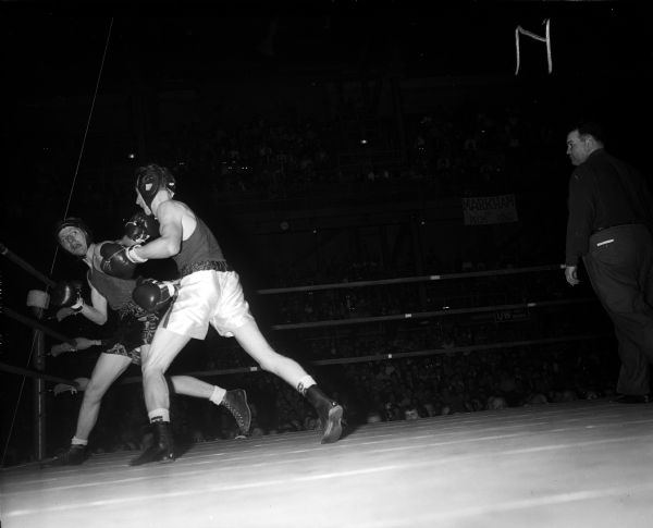 Jim Reardon of DePaul jabs a left hook into the face of Steve Gremban of Wisconsin during the 125-pound boxing match.