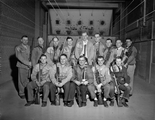 The Madison Rifle Club has won the Southern Wisconsin League Championship for the third straight year. The pictured sharpshooters won the 1949-50 title with a record of 18 wins and two defeats. Madison has won the title four out of the last five years.
This year's championship squad established a new record-high team score in the league with a 1,470 out of a possible 1,500 in three positions: prone, sit, and standing.
Members of the Madison team from left to right are: Back row, G. Bonn, M. Severson, R. Wallace, A. Denmann, J. Thompson, F. Jenks, Russ Pope, Dr. Claude Reading, C. Standorf. Front Row: R. Bittner, Ted Church, Forrest "Pops" Henderson, Sgt. Jim Bruhy, E. and Pederson.  Jerry Moen, L. Reinke, and A. Anderson were absent when the picture was taken.