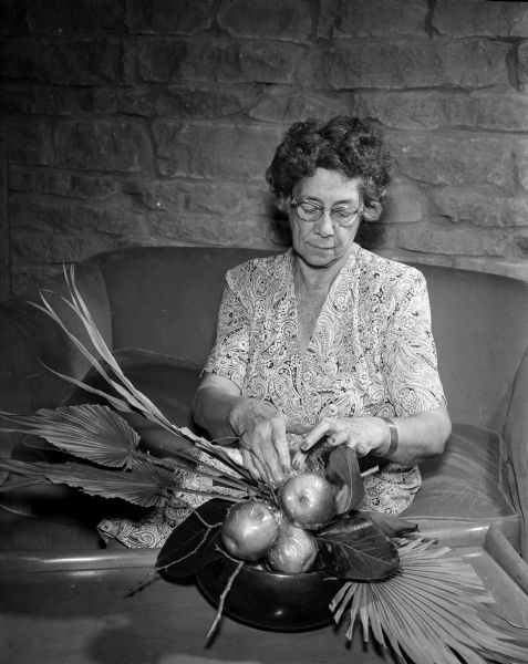 Caroline Peterson of Honolulu, Hawaii, recognized expert in flower arranging, will give a public presentation today at 3 PM at the Great Room of the Memorial Union. This photograph was taken in the Maple Bluff home of her intimate friends Mr. Robert O. and Mrs. June D. McLean on 200 Lakewood Boulevard during her 2 week visit.