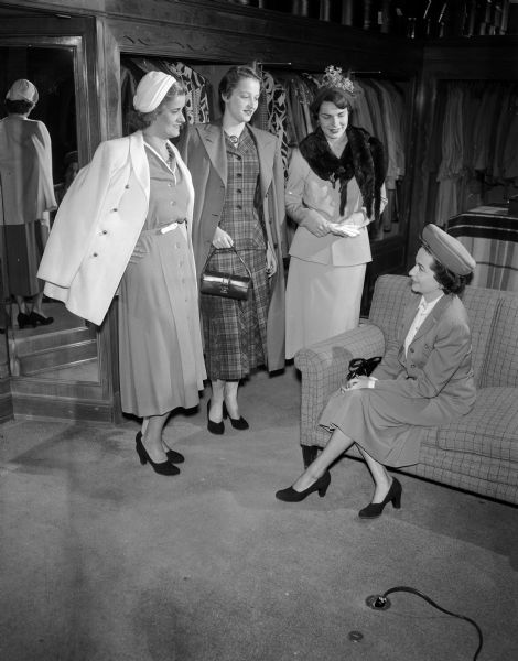 Mrs. Stephen E. (Kathryn) Gavin of 2811 Monroe Street, chairman of the Kappa Kappa Gamma Alumnae benefit dessert bridge party and style show, sitting at right with three of the models from the show. They are, from  left to right, Mrs. C.G. (Sara) Reznichek, 1245 Morrison Court; Miss Margot Schmidt, 1937 Arlington Place and Mrs. Thomas Reghanti, 661 Mendota Court.