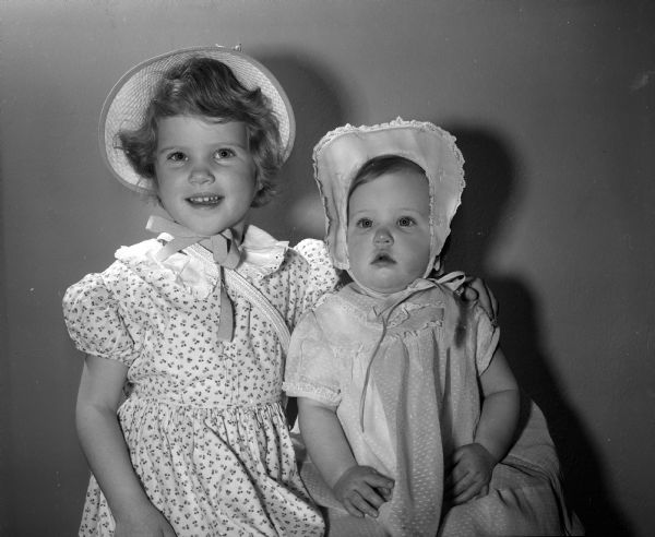 Anne McLean Anthony, age 4, and Deborah Anthony, age 1, are dressed in dresses and bonnets for Easter. They are the daughters of Robert W. and Nancy M. Anthony of 210 Forest Street.